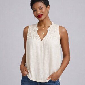 Size XS sleeveless top. WE THE FREE loose fit ivory shirt with exposed seams